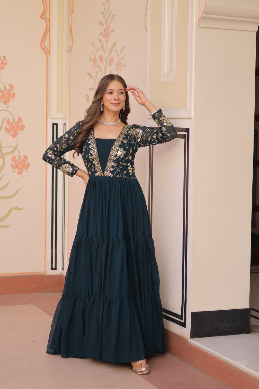 Woman in tiered green gown with zari embroidery