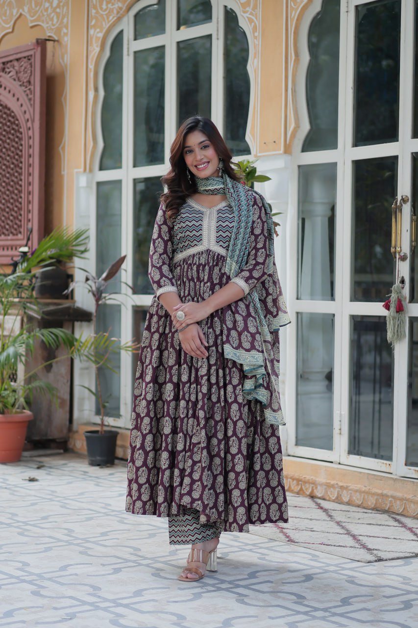 Maroon and gold ethnic cotton kurti suit with teal chevron dupatta, Anarkali silhouette, model smiling outdoors.