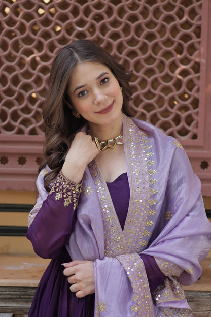 Close-up of gold embroidered details on a purple gown and dupatta.