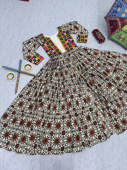 Flat lay of Kachchi Charm lehenga choli set, mirror work shrug, and skirt with dandiya sticks and bangles.
