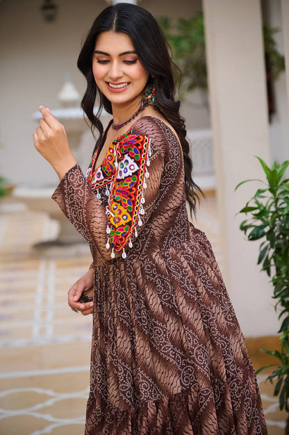 Side profile of brown Bandhni gown, highlighting detailed embroidery and joyful festive look.