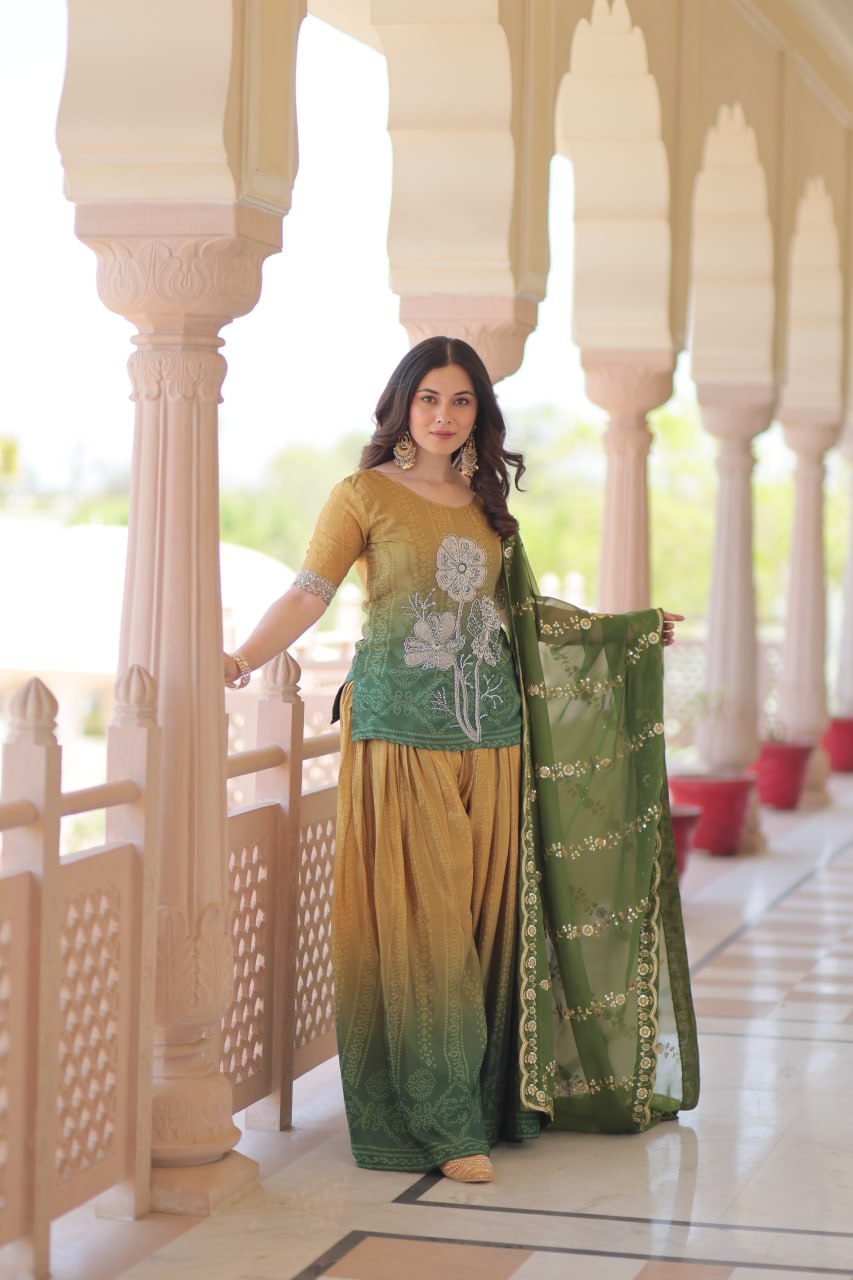 Woman in olive green Sharara Suit with zari embroidered dupatta