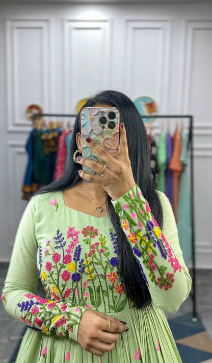 Close-up of the light green Floral Elegance dress, showcasing the chain stitch embroidery.
