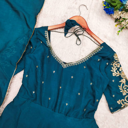 Close-up of the teal Morpankh Anarkali, showcasing the embroidery and Vichitra silk fabric.
