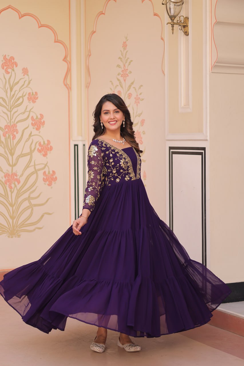 Smiling model in purple gown with gold embroidery