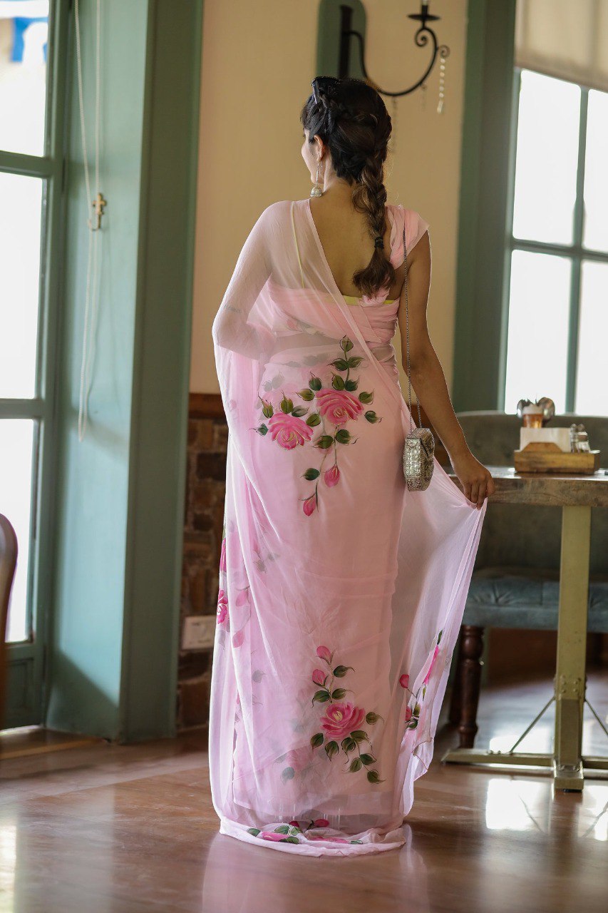 Close crop of hand-painted rose detail on pink georgette saree.