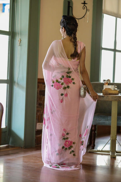 Close crop of hand-painted rose detail on pink georgette saree.