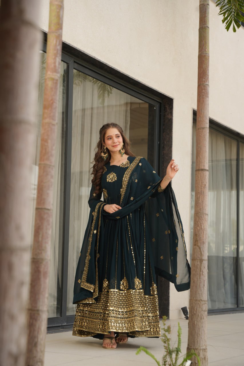 Woman wearing a Rama green gown with dupatta, outdoor fashion shot.